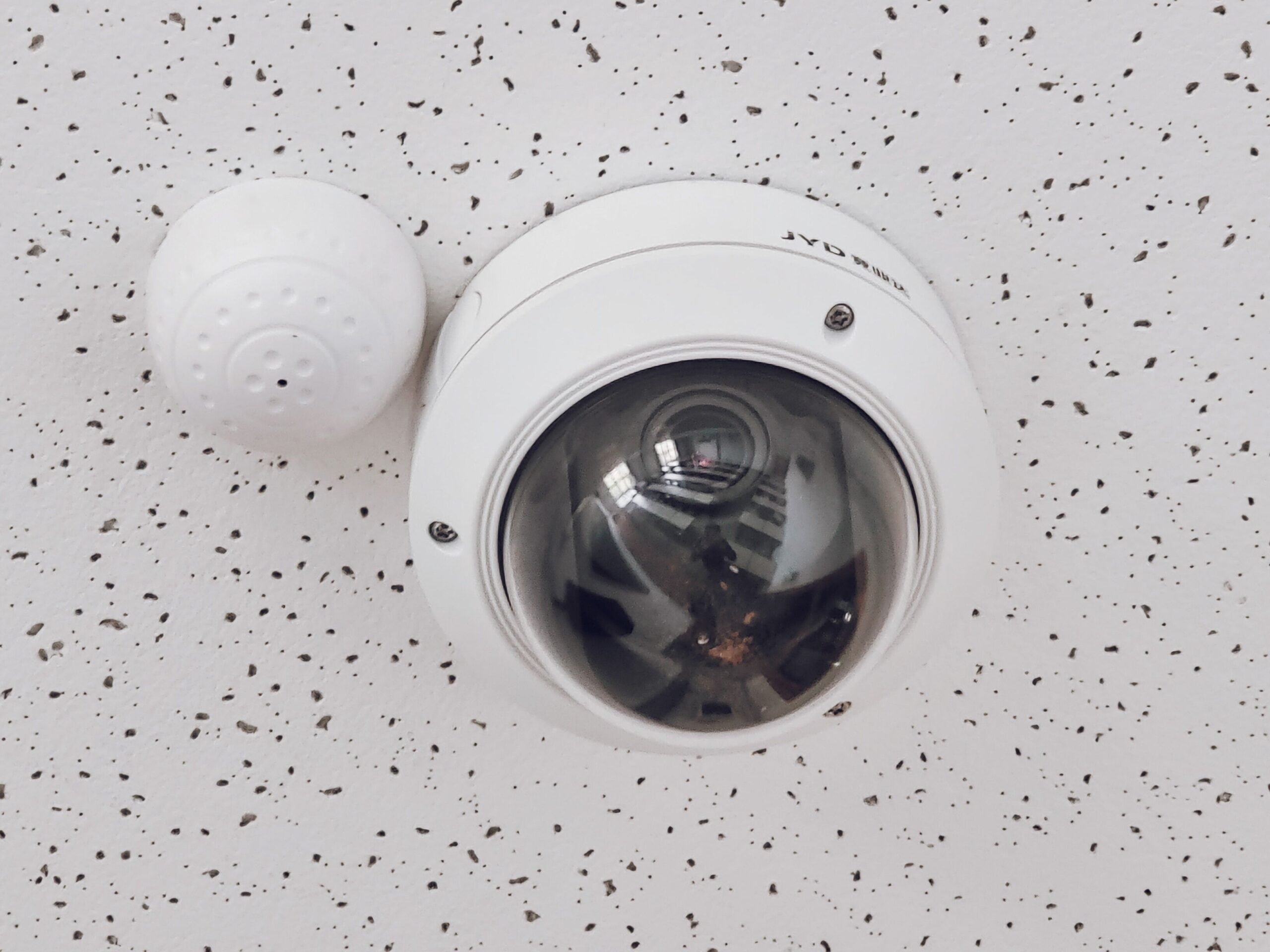 Ceiling‑mounted dome CCTV camera with sensor representing essential security infrastructure for hotels and restaurants in Kenya.