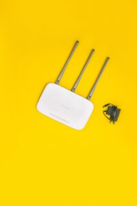 White TP‑Link wireless router with antennas and power adapter symbolizing office Wi‑Fi solutions in Nairobi
