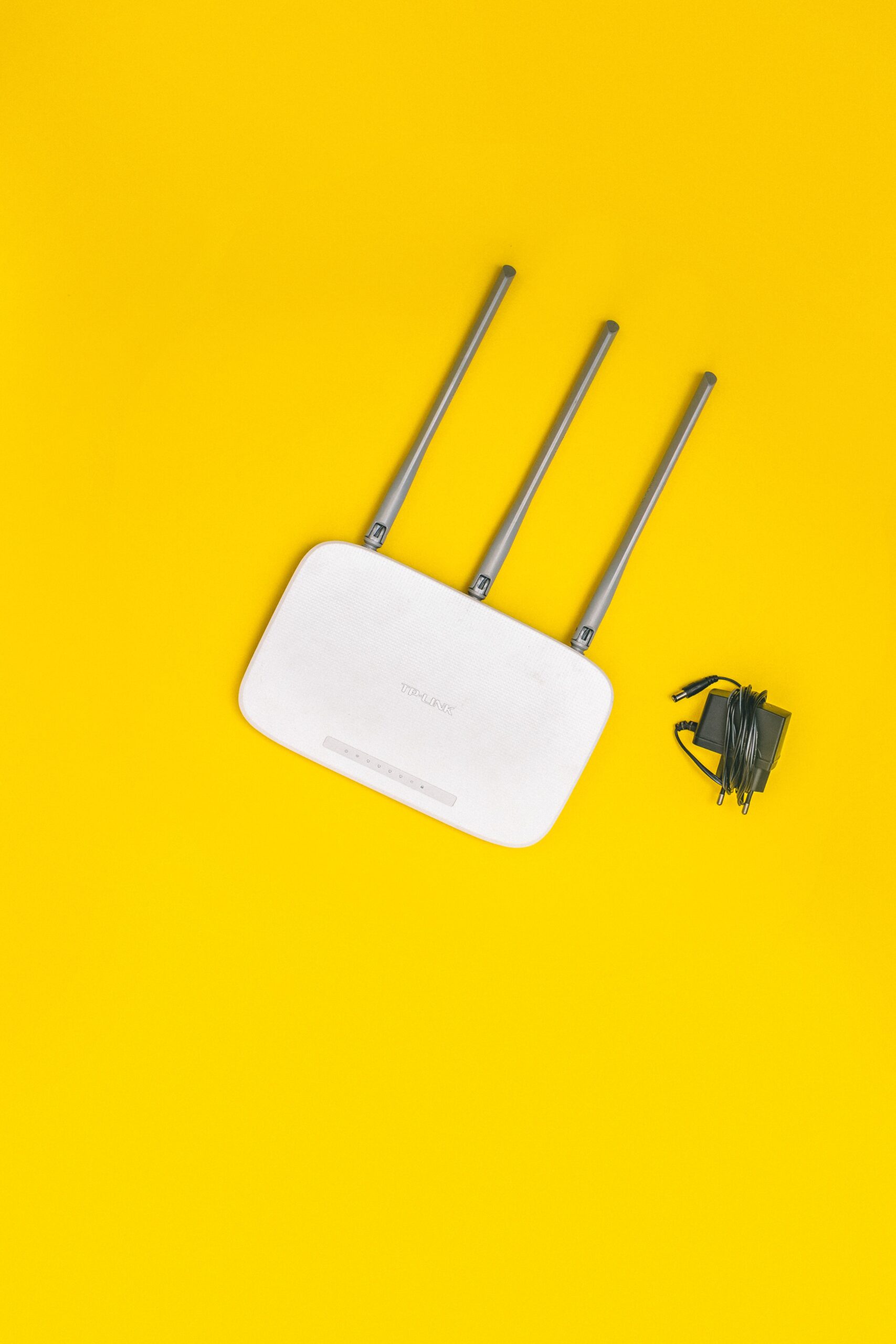 White TP‑Link wireless router with antennas and power adapter symbolizing office Wi‑Fi solutions in Nairobi